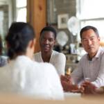 A diverse group of people seated together in a professional setting, reflecting the human complexity explored in schema therapy